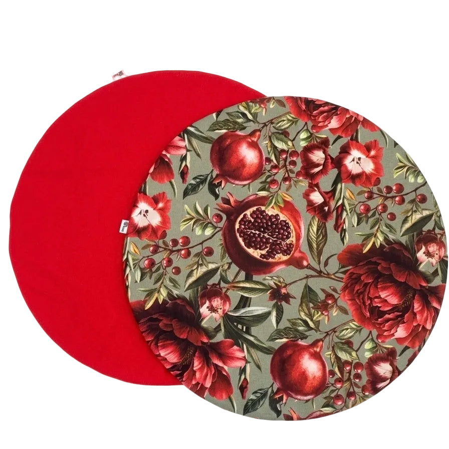Mantel individual redondo reversible de algodón con estampado floral de granadas en tonos rojos y fondo verde agua. revés rojo. Diseño elegante y original para vestir la mesa con personalidad.