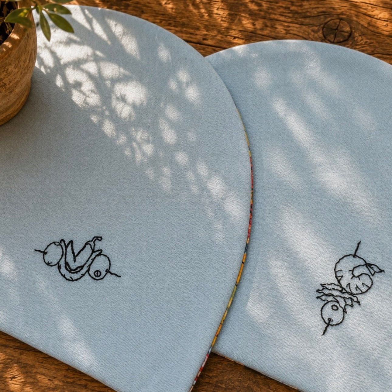 Pack de dos manteles reversibles bordados a mano con una banderilla o gilda